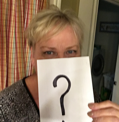 questions about Lipedema surgery | photo of Denise holding up a piece of paper with a question mark on it